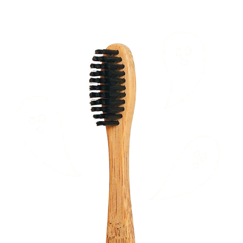 Charcoal infused bamboo toothbrush with compostable handle.
