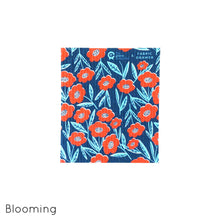 Organic cotton dish cloth in Blooming design, featuring red flower on navy background.