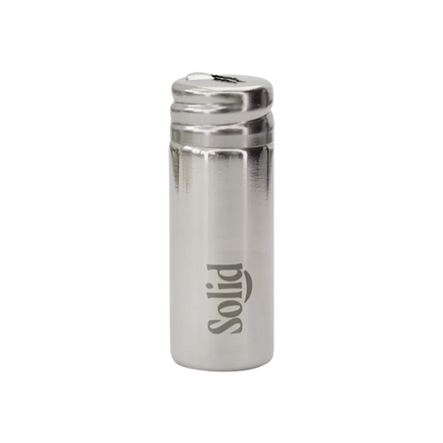 Stainless steel refillable dental floss container by Solid Oral Care. Silver in colour with the Solid logo etched onto the side.