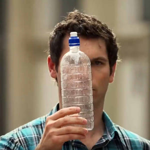 Man holding single-use plastic bottle.