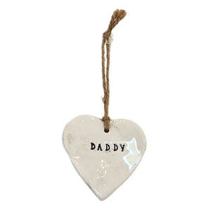 Beautiful white hanging heart embossed with the word "Daddy" which are black, with a jute string to hang your heart up with.