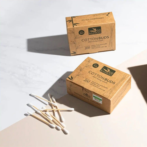 Go bamboo cotton buds in recycled cardboard boxes and cotton buds laying in the foreground.