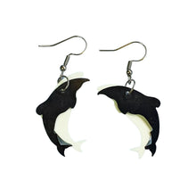 Hector's Dolphins earrings made by Remix Plastic from recycled plastic ice cream container lids. Here you can see the separate white and black plastic pieces that come together to form the unique dolphin outline.