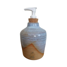 Ceramic hand soap / liquid dispenser bottle hand made by Wellhandled Ceramics. Buff clay with a light blue cross dipped glaze.