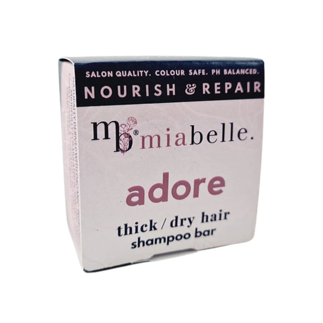 Mia Belle Adore thick / dry hair shampoo bar. Packaging pictured is a nice cool pink with a navy stripe across the top. The packaging reads: Salon quality, colour safe, ph balanced. Nourish and repair.