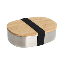 Stainless steel lunchbox with bamboo lid and a wide black fabric elastic band holding the lid in place. Sleek, stylish and minimal design.