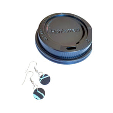 Raw materials: black circular disk earrings and a black single-use plastic coffee cup lid by Remix Plastic.