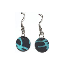Black circular earrings made from recycled single-use coffee cup lids by Remix Plastic.