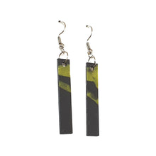 Long black earrings with gold accents made from recycled single-use coffee cup lids by Remix Plastic.
