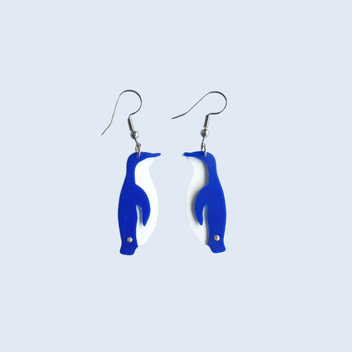 Little Blue Penguin / Kororā earrings made by Remix Plastic from recycled plastic ice cream container lids. Here you can see the separate white and blue plastic pieces that come together to form the unique penguin outline.