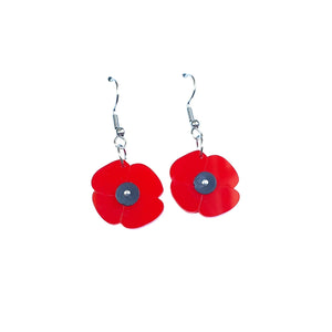 Remix Plastic's Poppy flower earrings made from recycled acrylic offcuts. Red flowers with black centre made from ice-cream container lids. Hook closure, seen here hanging on a white background.