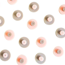 Nipple earrings that support Breast Cancer Foundation New Zealand, made by Remix Plastic from salvaged plastic, a production line of nipple earrings seen here.