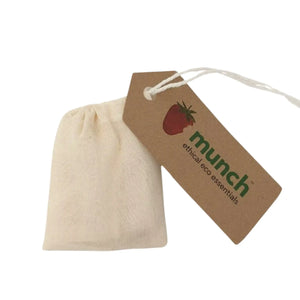 Cream cotton reusable teabag with a drawstring and a tag that reads "Munch ethical eco essentials".