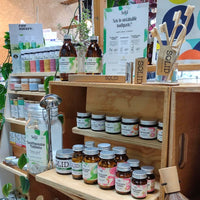 Earthlove's range of Solid oral care products, this shop display includes wooden shelving with rows of mouthwash, toothpaste, toothpaste tablets, bamboo toothbrushes and toothpaste tablet refills. Natural deodorants & plants can be seen in the background.