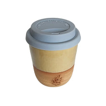 An espresso sized ceramic travel take-away coffee cup by Wellhandled Ceramics in a creamy toffee coloured glaze with a buff clay and a grey coloured silicone lid.