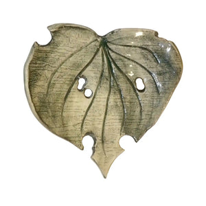 Decorative ceramic kawakawa leaf dish by Wellhandled Ceramics. Dark green with moth holes and leaf veins carved into the surface.