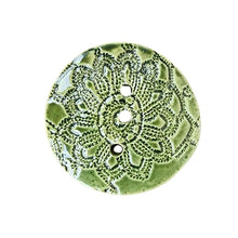 Green circular ceramic soap dish handmade by Wellhandled Ceramics with 3 drainage holes and embossed with lace.