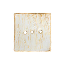 Creamy honey coloured ceramic soap dish handmade by Wellhandled Ceramics. Square shape, textured surface with 3 drainage holes.