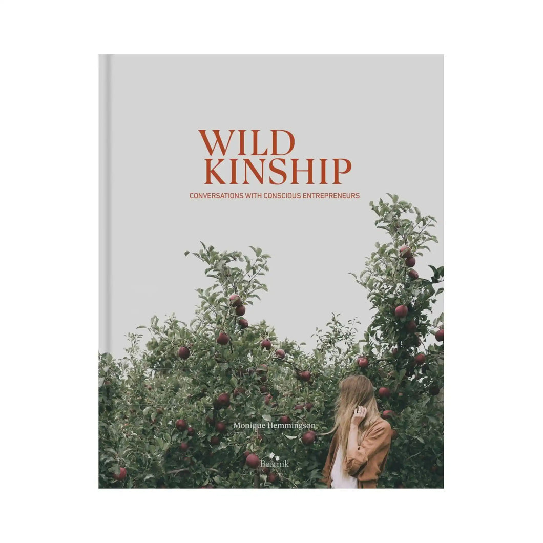 Cover of Wild Kinship : Conversations with Conscious Entrepreneurs book by Monique Hemmingson and published by Beatnik Publishing. Image on front cover shows a woman turned away from the camera with long blonde hair in an apple orchard.