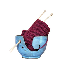 Ceramic yarn / wool bowl to hold your knitting or crochet project and keep it safe. A hand carved koru swirling shape on the side. Hand thrown in Christchurch and glazed with a silky light light blue slightly speckled glaze. Seen here with deep red yarn and bamboo knitting needles.
