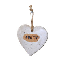 Beautiful white hanging heart embossed with the letters Aunty, with a jute string.