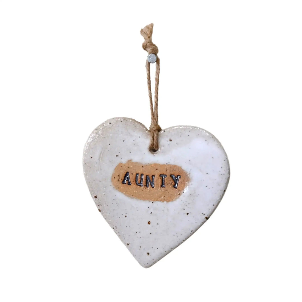 Beautiful white hanging heart embossed with the letters Aunty, with a jute string.