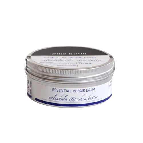 A silver aluminium tin containing Blue Earth Essential Repair Balm with Calendula and Shea Butter. Label reads 100% natural.