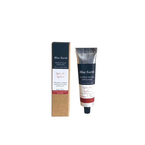 A silver aluminium tube containing Blue Earth Gentle Facial Exfoliant with jojoba, rosehip and evening primrose oils. Cardboard box packaging stands to the left of the tube and reads Natural plant-based skincare.