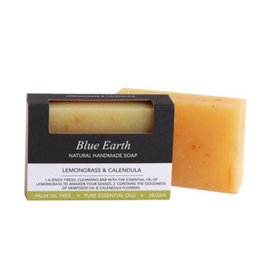 Blue Earth Lemongrass & Calendula Soap bar, pictured with one bar packaged and one bar standing to the right and slightly behind. Label reads: Natural Handmade soap.