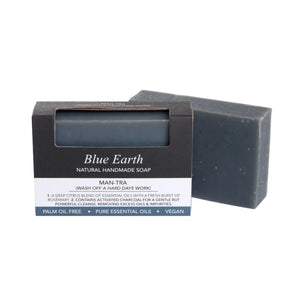 Blue Earth Man-tra Soap bar, pictured with one bar packaged and one bar standing to the right and slightly behind. Label reads: Natural Handmade soap.