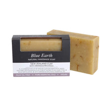 Blue Earth New Zealand Clay Soap bar with Orange and Patchouli, pictured with one bar packaged and one bar package free. Label reads: Natural Handmade Vegan soap.