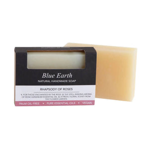 Rhapsody of Roses soap bar by Blue Earth, pictured with one bar packaged and one bar package free. Label reads: Natural Handmade Vegan soap.