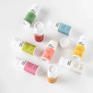 A colourful selection of natural deodorants in white cardboard tubes and different coloured labels (green, blue, red, pink, yellow, lime, peach and mustard) depending on the scent of the deodorant.