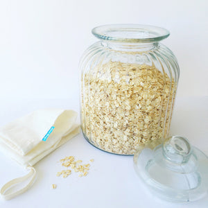 Organic cotton loot bag with glass jar full of oats.