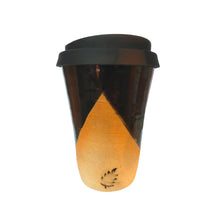 A ceramic large latte sized travel coffee cup with a mountain feel with black skies, sandy mountain base and a black silicone lid.