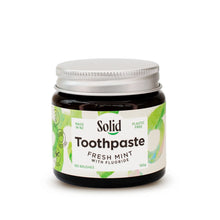 Solid Oral Care fresh mint toothpaste with fluoride in an amber glass jar. The label reads made in NZ and plastic free.