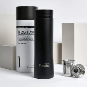 The whole package - here is the two part Fressko tea infuser alongside the water bottle / insulated flask. This sleek black stainless steel flask is stylish in matt black with the Fressko logo engraved to reveal the silver of the stainless steel. In the background is the white and black cardboard tube that the flask is packaged in - altogether a lovely, sustainable gift.