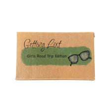 Girl's Road Trip edition of the Getting Lost Adventure game in a kraft cardboard box with a green cloud and a pair of ladies spectacles on the front.