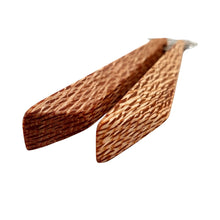 Wooden earrings made from recycled Rewarewa wood by Liberation Jewellery. Stunning close-up shot of the patterned grain.