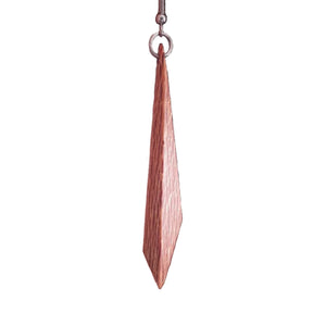 One hanging wooden earring made from recycled Rewarewa wood by Liberation Jewellery. Nice detail of the patterned grain can be seen along with with stainless-steel fixings.