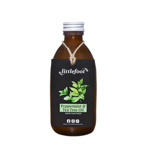 Littlefoot Hand Sanitiser in an amber glass bottle with a white cap. Swing tag reads peppermint and tea tree oil scent with an image of peppermint and tea tree leaves. Stops germs in their tracks. 