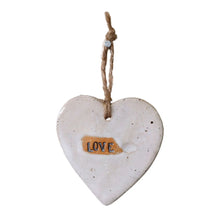 Beautiful white hanging heart embossed with the letters "Love". The heart has a jute string attached to hang your heart up with.
