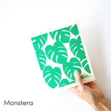 The Green Collective dish cloth with large green monstera leaf design.