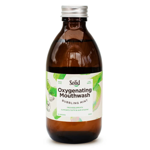 Solid Oral Care's Oxygenating Mouthwash in an amber glass bottle. Label reads: Freshens breath and supports teeth and gum hygiene.