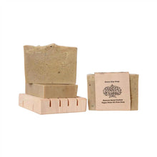 Panna Soaps handcrafted vegan Green Clay soap with simple brown paper packaging and stacked on top of a wooden soap dish.