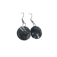 Black and white circular plastic earrings made from recycled 3D printer waste by Remix Plastic.