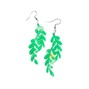 Remix Plastic's Kōwhai leaf earrings made from recycled 3D printer waste. Green leaves with hook closure, seen here laying on a white background.