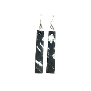 Straight and narrow black and white plastic earrings made from recycled 3D printer waste by Remix Plastic.