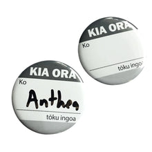 Two reusable name badges which read "kia ora, ko ...... tōku ingoa" which means "Hello, my name is ...." in te reo Māori or the Māori language. One badge has the name Anthea which as been written with a black whiteboard marker.