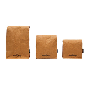 Reusable coffee bean bags made from machine washable kraft paper. Available in three sizes which are seen here in the natural, kraft brown colour in the 1kg, 500g and 250g coffee pouch size with the SammyBags branding.
